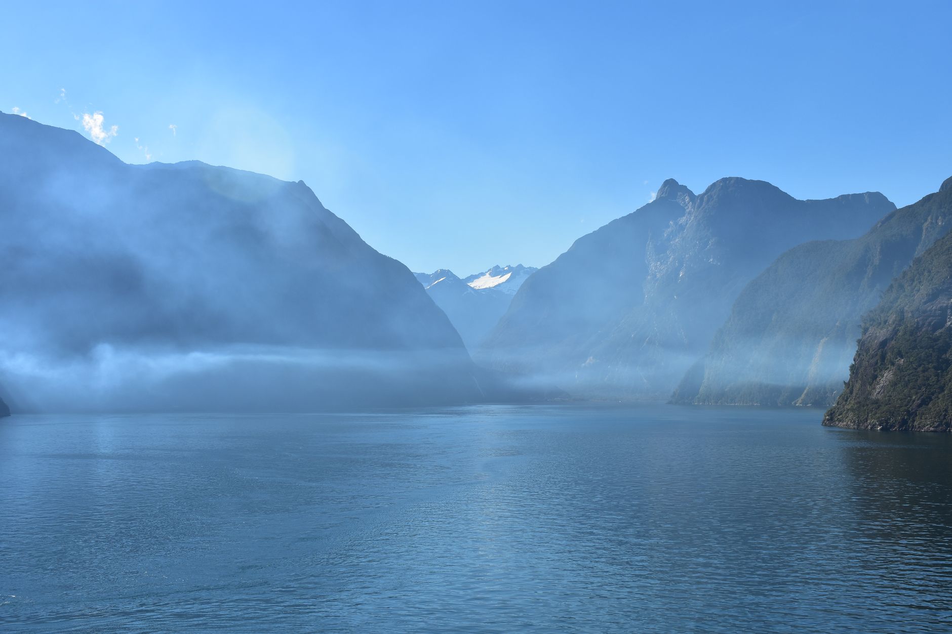 Dramatic coastal mountain range and deep misty fjords
